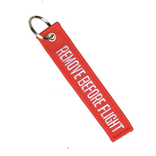 Levně Klíčenka: REMOVE BEFORE FLIGHT červená
